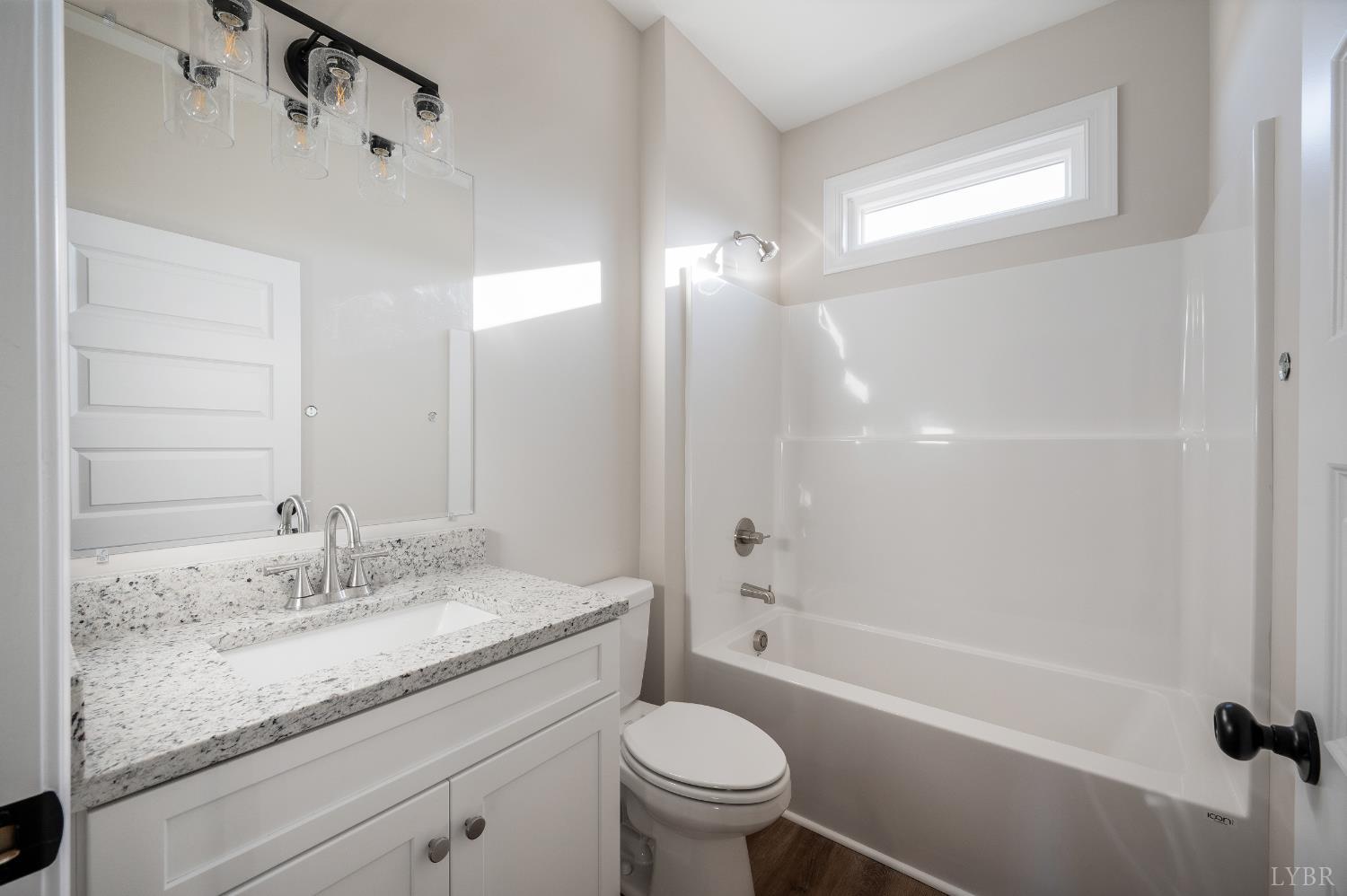 10402 Leesville Road Lynch Station, VA 24571 - Photo 32 of 45 a bathroom with a granite countertop sink a toilet and shower