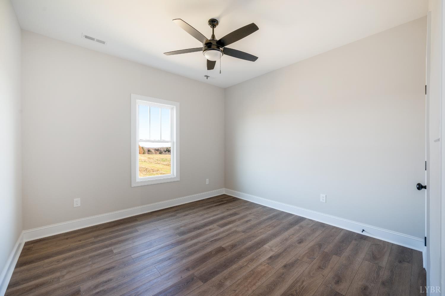 10402 Leesville Road Lynch Station, VA 24571 - Photo 33 of 45 an empty room with wooden floor and windows