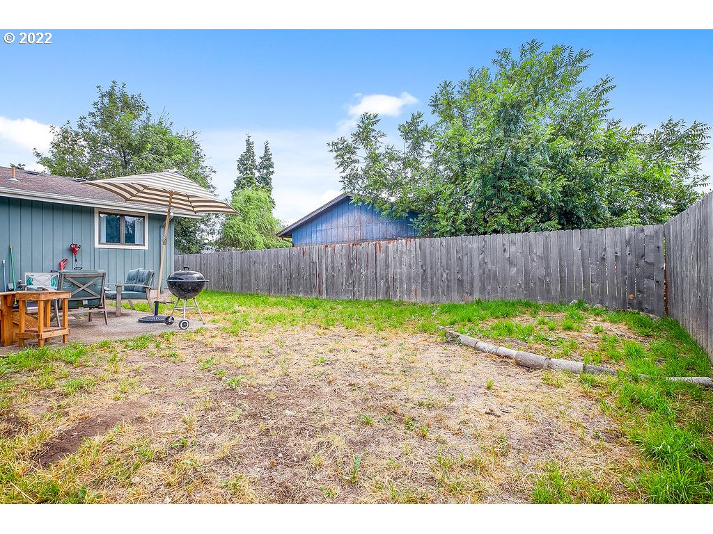 581 36th Street Springfield, OR 97478 - Photo 31 of 32 a view of a backyard with table and chairs with wooden fence