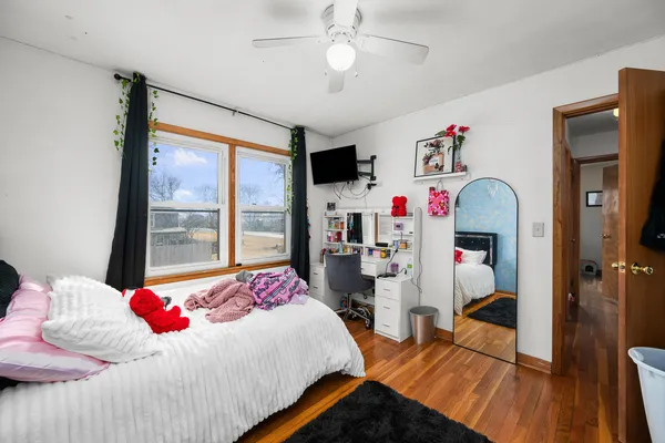 a bedroom with bed and a large window