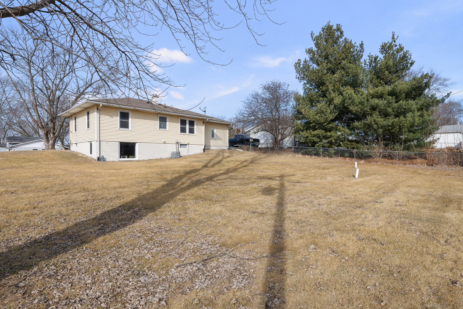 13627 138th Street West Taylor Ridge, IL 61284 - Photo 20 of 23 a white house that has a tree in front of it