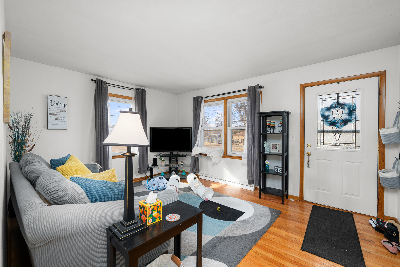 13627 138th Street West Taylor Ridge, IL 61284 - Photo 3 of 23 a living room with furniture a rug and a lamp