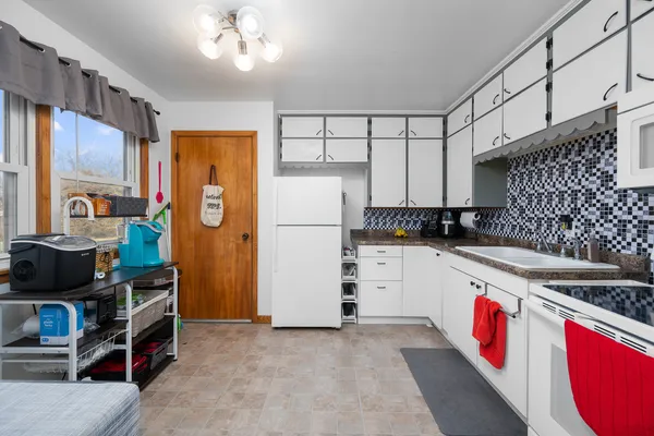 a kitchen with stainless steel appliances granite countertop a refrigerator stove and sink
