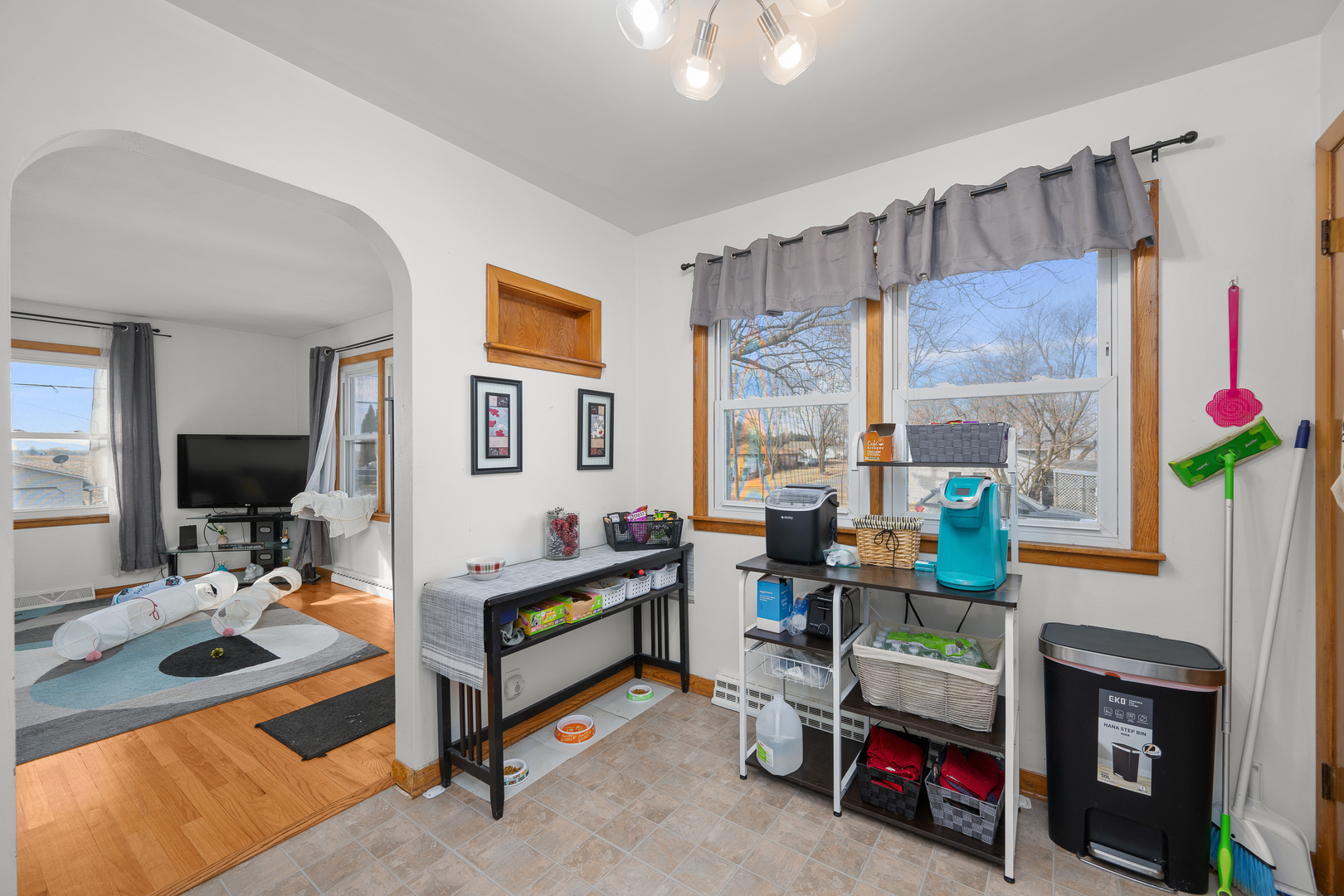 13627 138th Street West Taylor Ridge, IL 61284 - Photo 6 of 23 a living room with furniture a flat screen tv and a floor to ceiling window