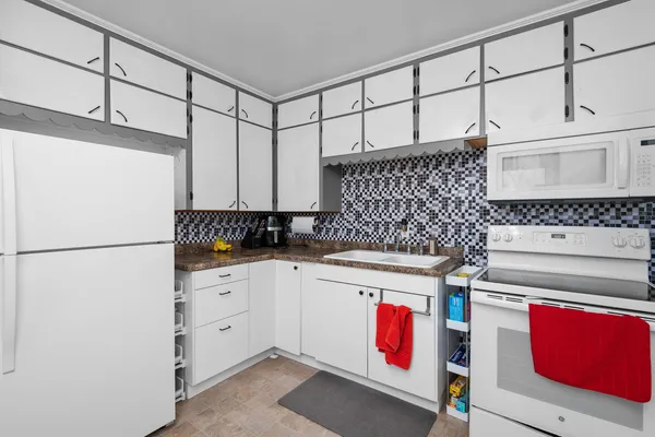 a kitchen with a refrigerator and a stove