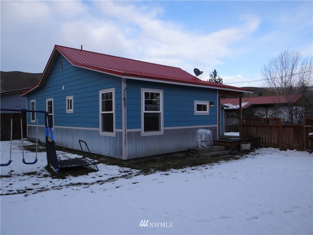 1306 Riverside Avenue Twisp, WA 98856 - Photo 1 of 22 a front view of a house with a yard