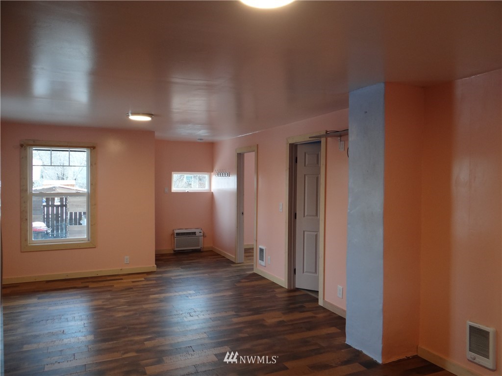 1306 Riverside Avenue Twisp, WA 98856 - Photo 12 of 22 a view of an empty room with wooden floor and a window