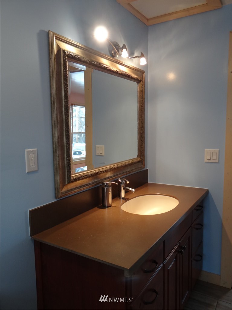 1306 Riverside Avenue Twisp, WA 98856 - Photo 17 of 22 a bathroom with a sink vanity and mirror