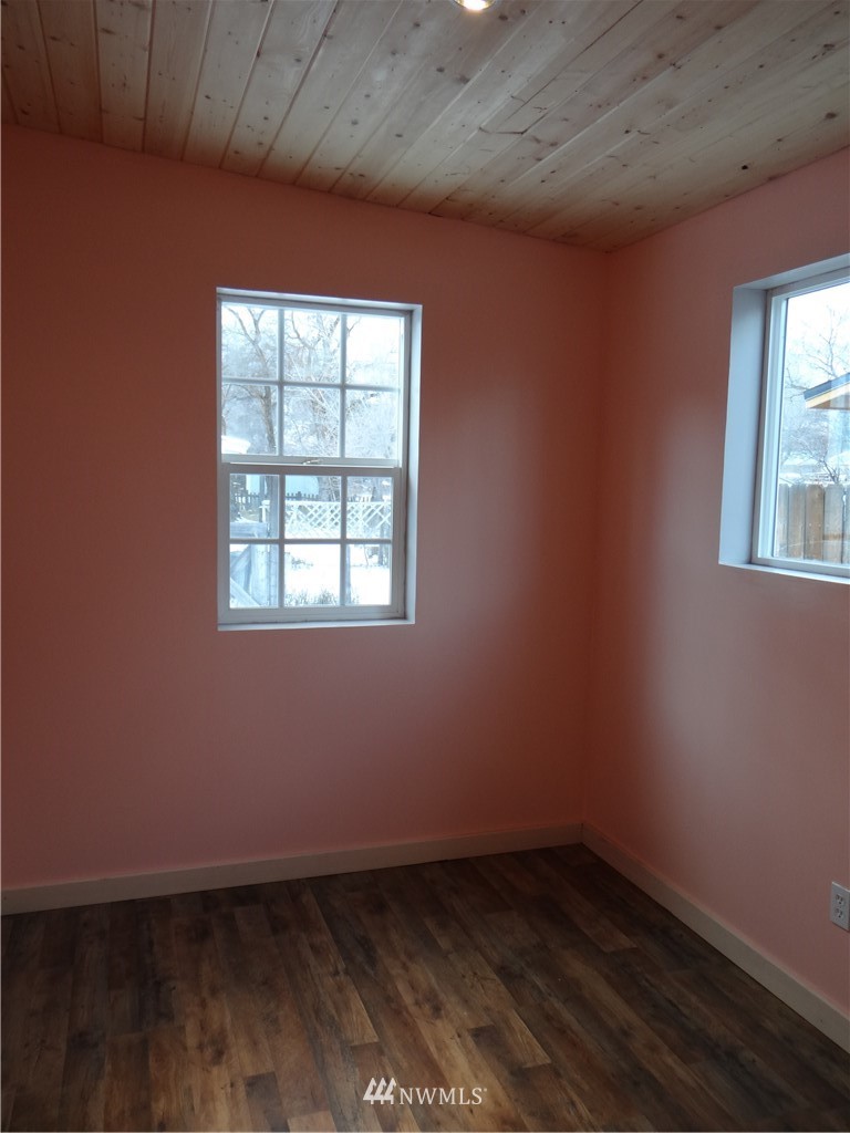 1306 Riverside Avenue Twisp, WA 98856 - Photo 20 of 22 an empty room with wooden floor and windows