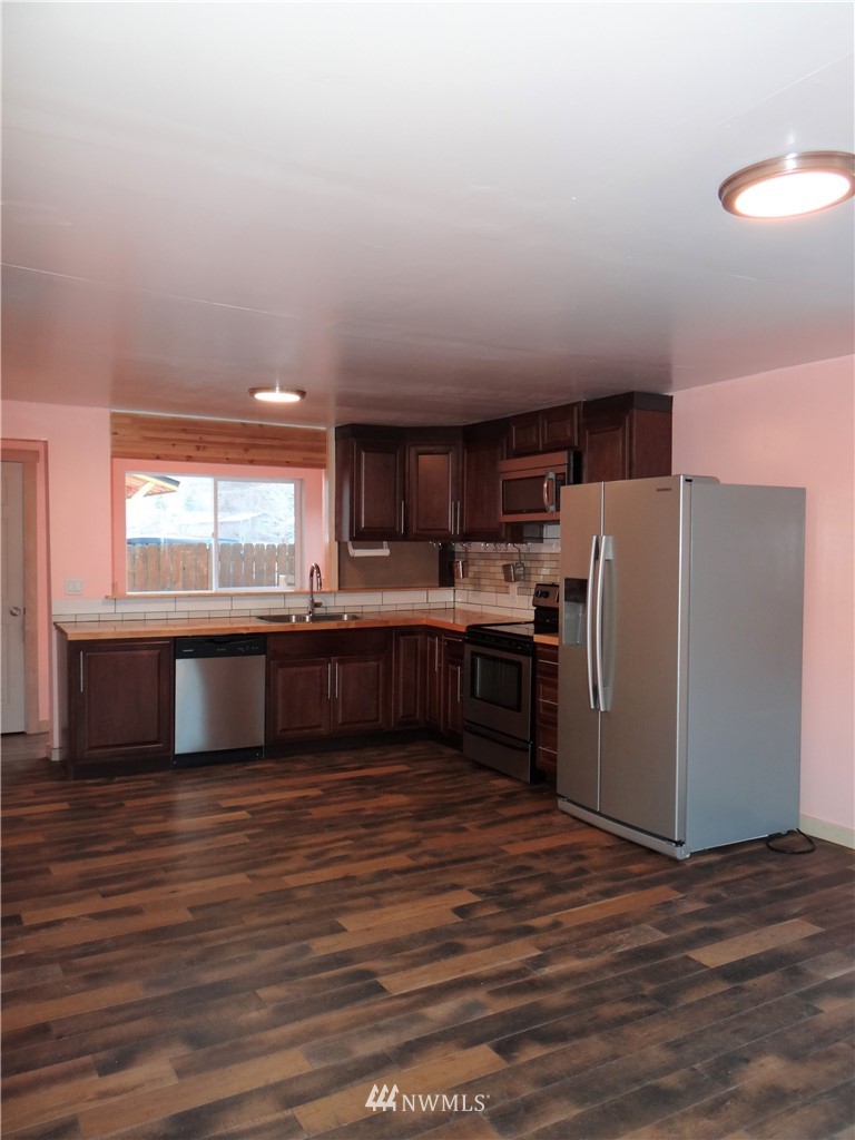 1306 Riverside Avenue Twisp, WA 98856 - Photo 5 of 22 a kitchen with stainless steel appliances a refrigerator and a stove top oven