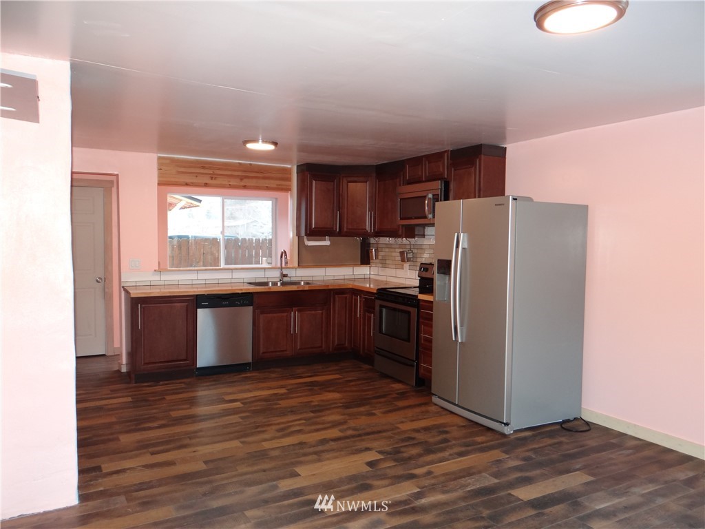 1306 Riverside Avenue Twisp, WA 98856 - Photo 6 of 22 a kitchen with stainless steel appliances a refrigerator and a sink
