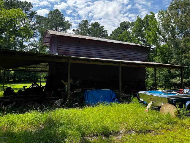 a view of a chairs and table in the backyard