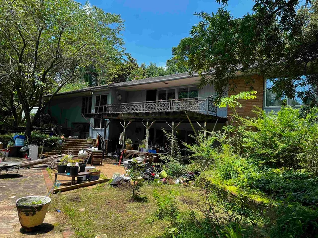 a view of backyard with swimming pool and sitting area