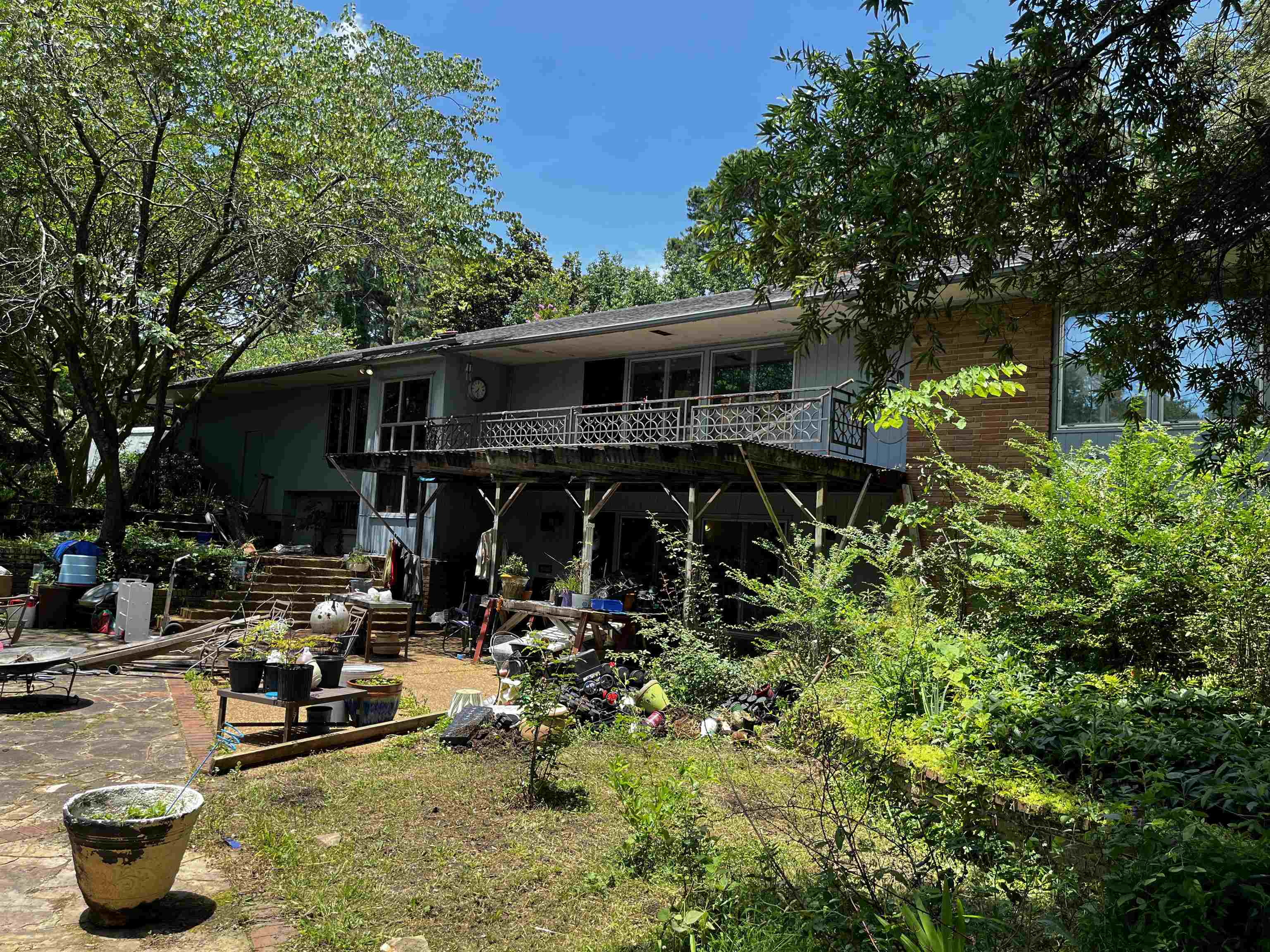 4258 Old Brownsville Road Memphis, TN 38135 - Photo 36 of 40 a view of a patio with table and chairs potted plants and large tree