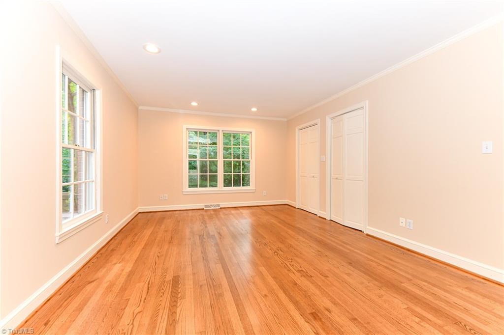 320 Homestead Avenue High Point, NC 27262 - Photo 12 of 31 The primary bedroom on the main level is located on the front of the home. Make note of the clean and buffed hardwoods, light filled, fresh paint, double closet, and recessed lighting.