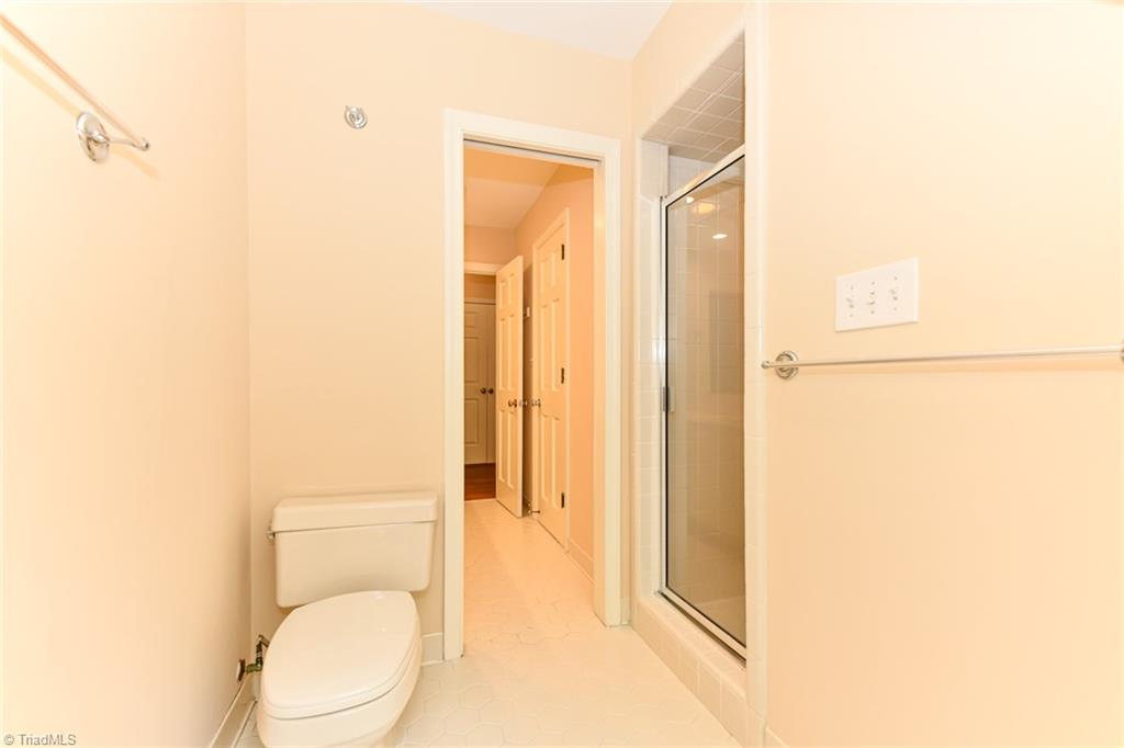 320 Homestead Avenue High Point, NC 27262 - Photo 23 of 31 The shower is separated from the double vanities. To the right, is the closet that connects with the 3rd bedroom. This 3rd bedroom could also, be used as a primary bedroom.