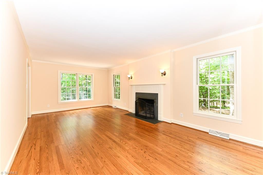 320 Homestead Avenue High Point, NC 27262 - Photo 5 of 31 To the left, when entering the foyer, is the living room. Newer sconces, wood burning fireplace, windows that allow the room to be filled with natural sunlight, and hardwoods that have been refinished, cleaned, and buffed.