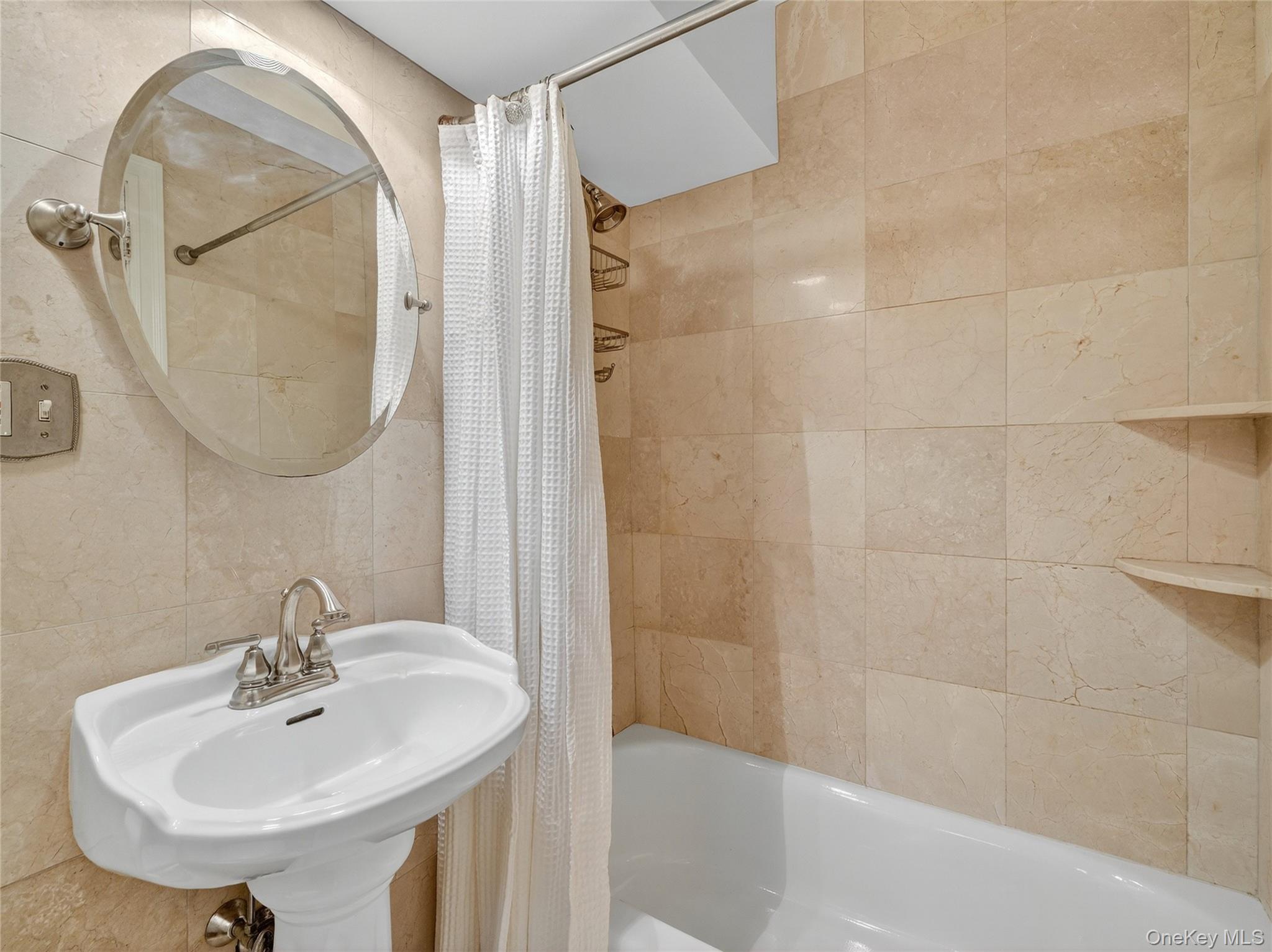 1 Rivermere, Unit I Bronxville, NY 10708 - Photo 11 of 20 a bathroom with a sink a shower and a mirror