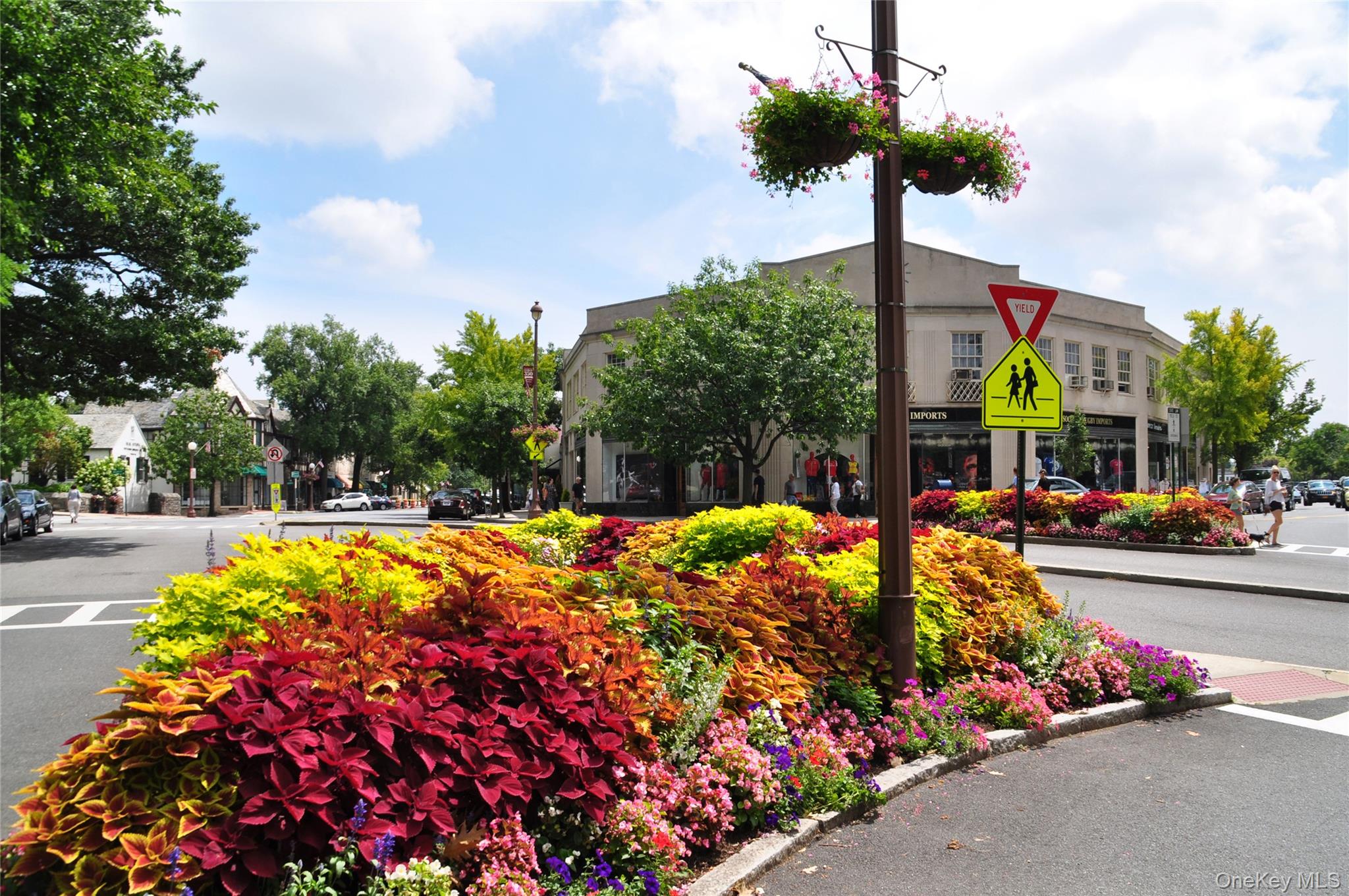 1 Rivermere, Unit I Bronxville, NY 10708 - Photo 20 of 20 a front view of multi story residential apartment building with yard and retail shops