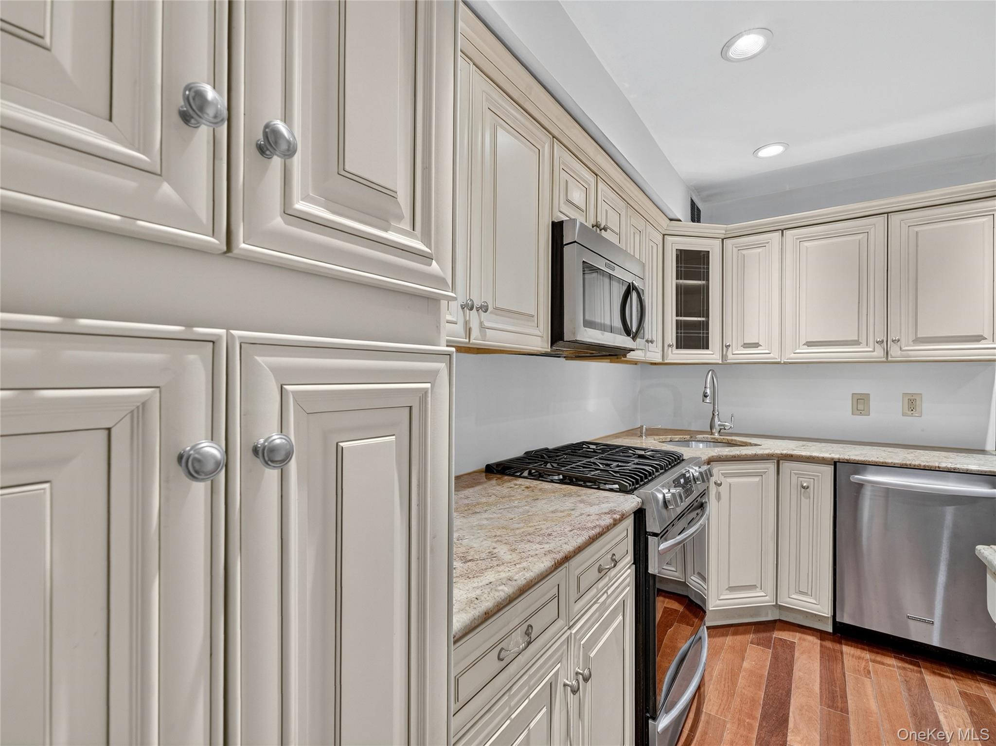 1 Rivermere, Unit I Bronxville, NY 10708 - Photo 6 of 20 a kitchen with stainless steel appliances granite countertop a stove and a microwave
