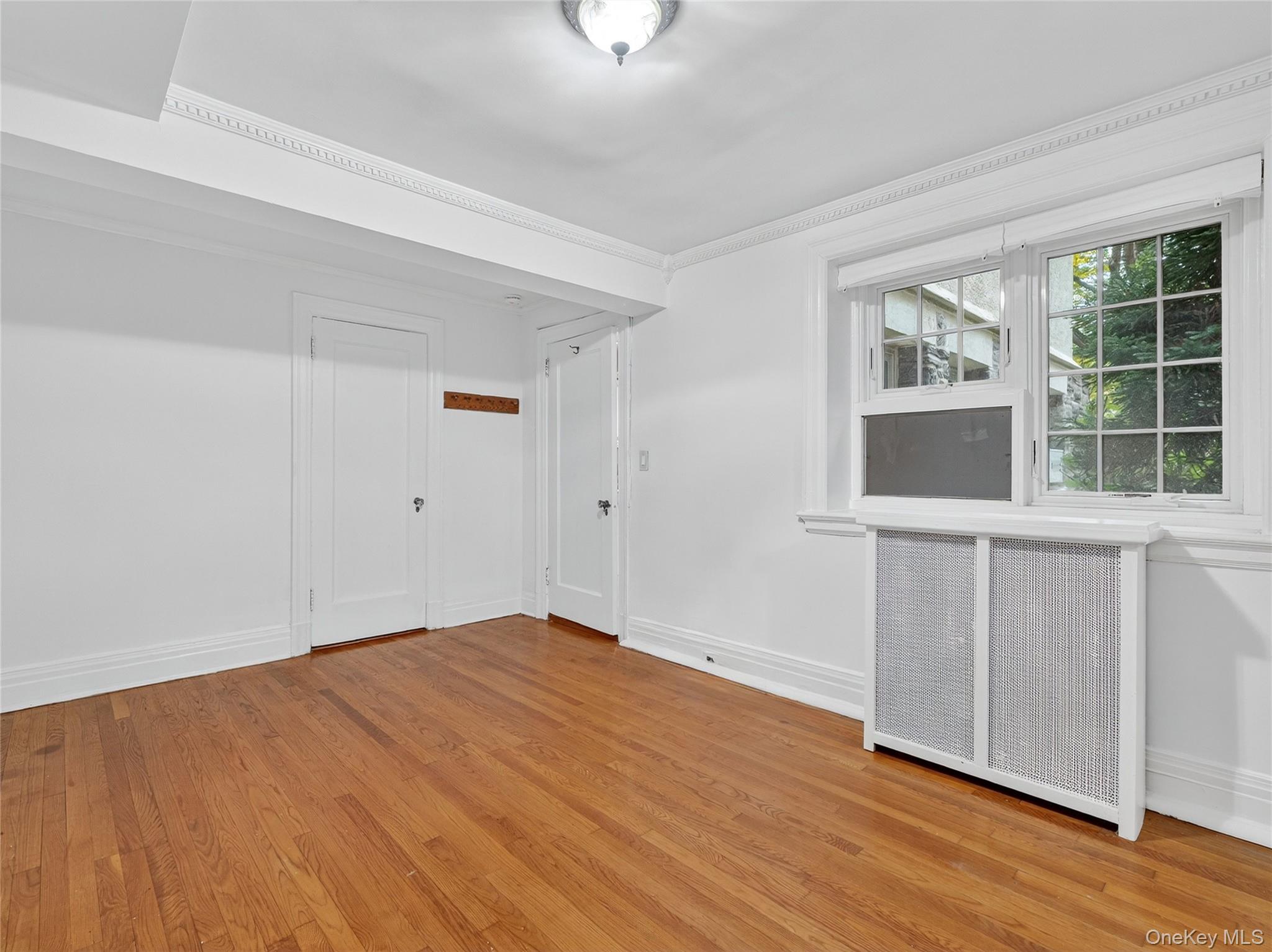 1 Rivermere, Unit I Bronxville, NY 10708 - Photo 10 of 20 a view of empty room with wooden floor and fan