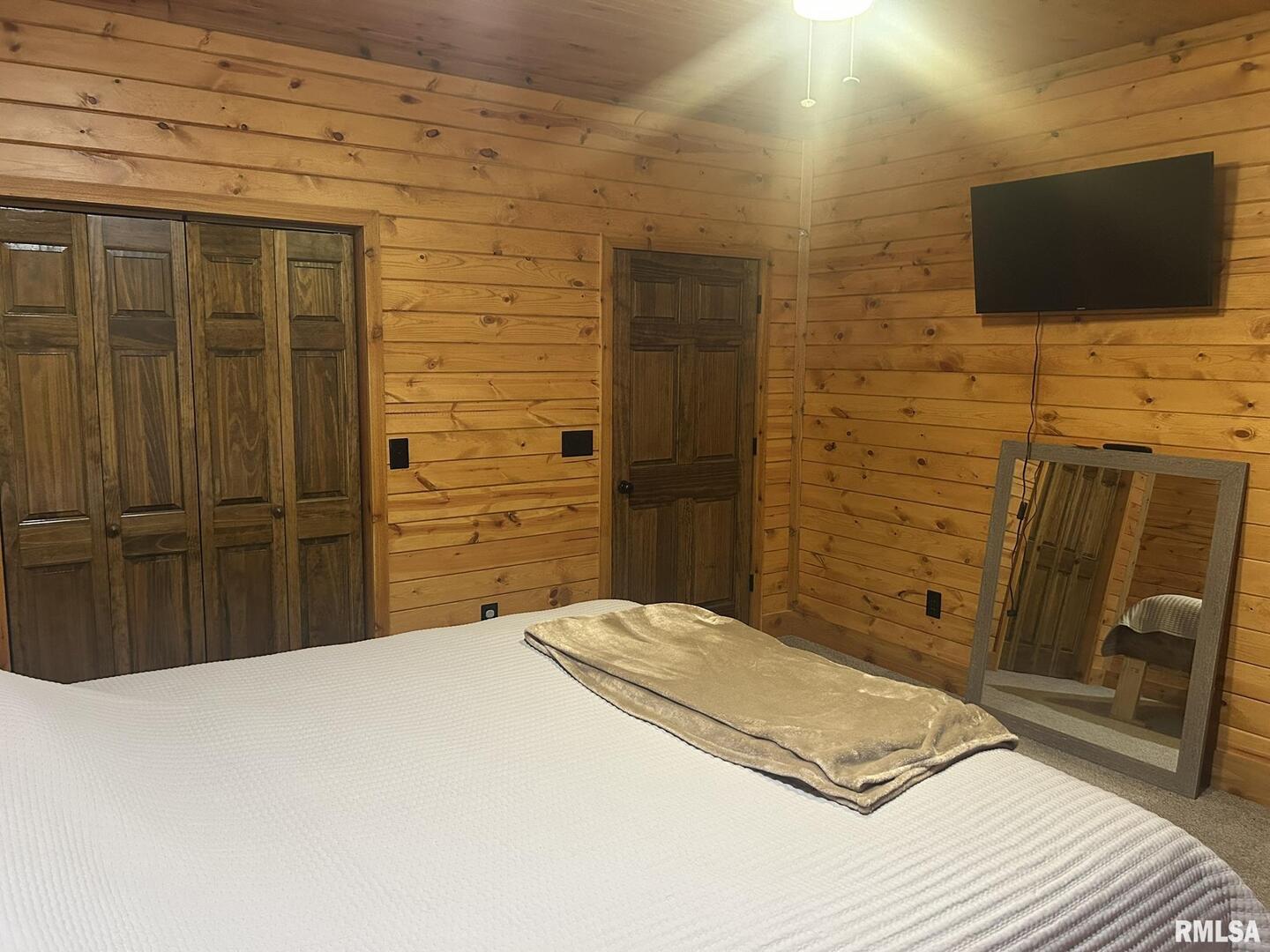 40 Presley Loop Golconda, IL 62938 - Photo 30 of 40 a bedroom with a bed and a flat screen tv