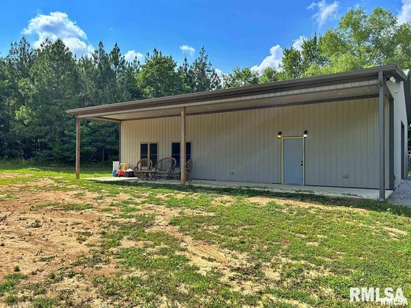 a backyard of a house with table and chairs