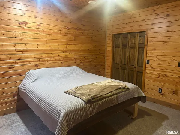 a bedroom with a bed and a shower