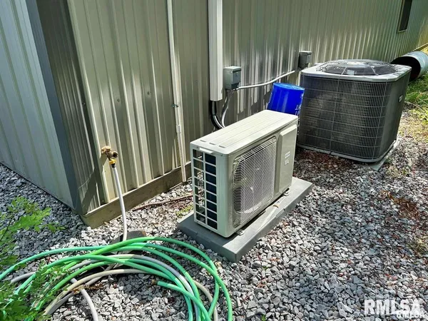 a utility room with a washer dryer and potted plants