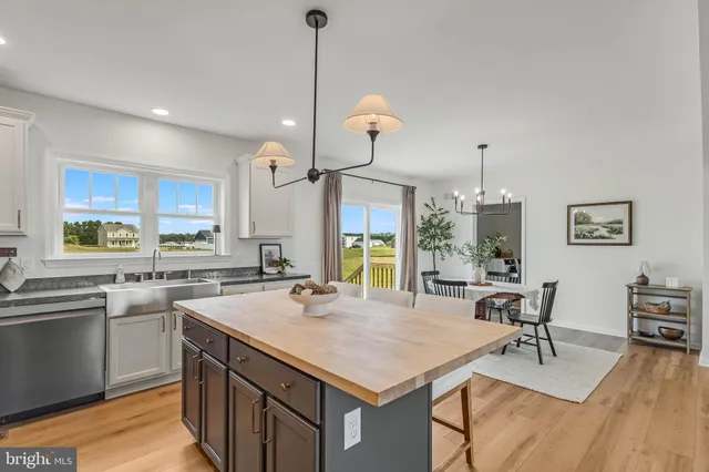 a kitchen with center island table and chairs