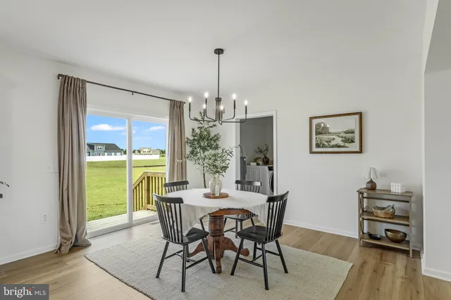 a dining room with furniture window and wooden floor