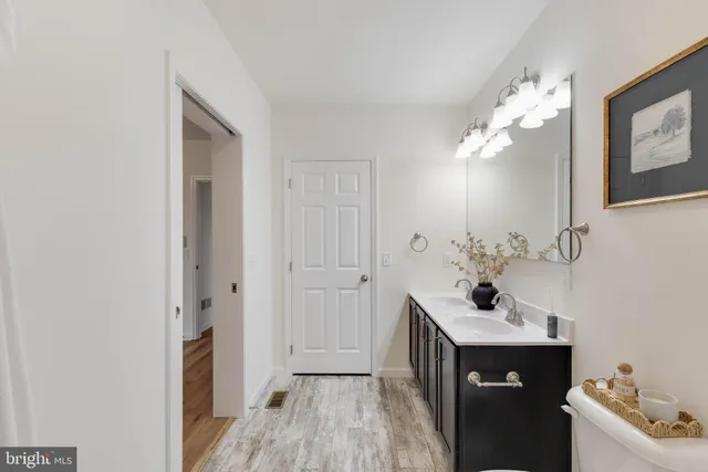 a bathroom with a sink a mirror and a toilet