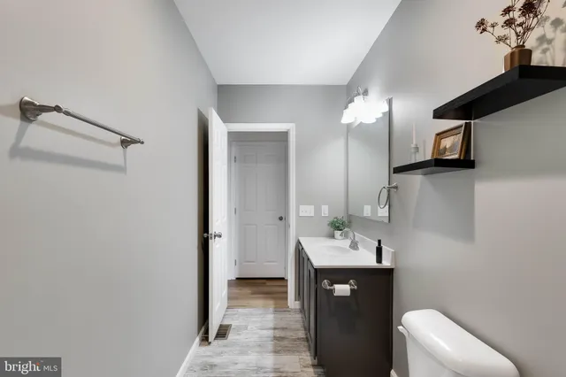 a bathroom with a sink a toilet and mirror