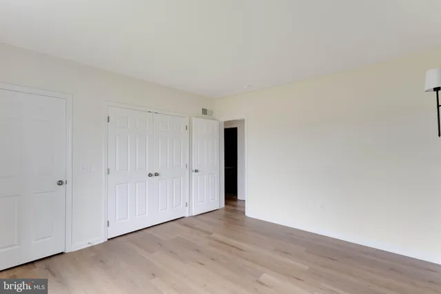 a view of an empty room and wooden floor