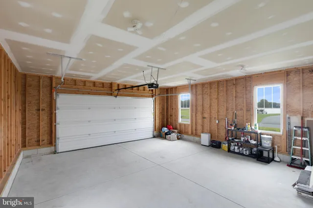 a view of room with gym equipment and windows
