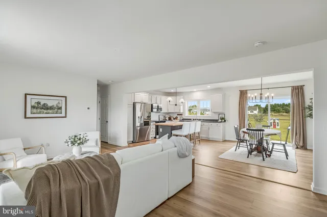 a living room with furniture and a table with wooden floor