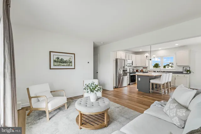 a living room with furniture and kitchen view