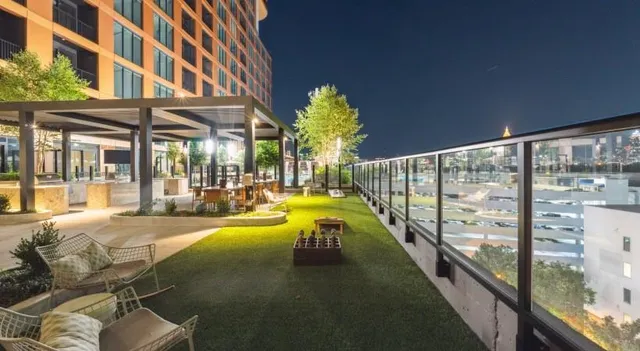 a view of a swimming pool with a yard and seating