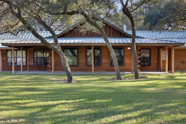 a front view of a building with a garden