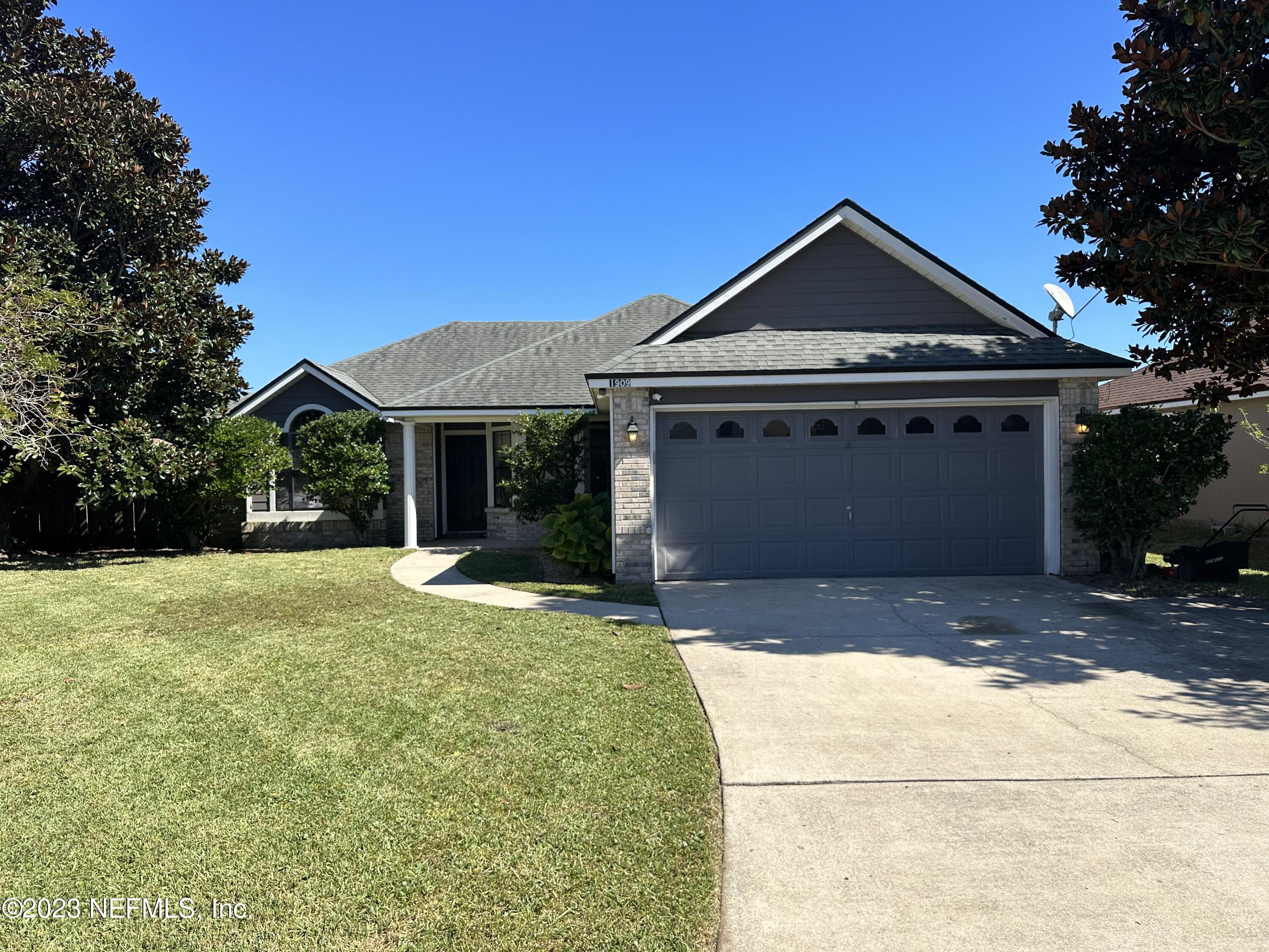 1909 Sutton Lakes Boulevard Jacksonville, FL 32246 - Photo 1 of 1 a front view of a house with a yard and garage