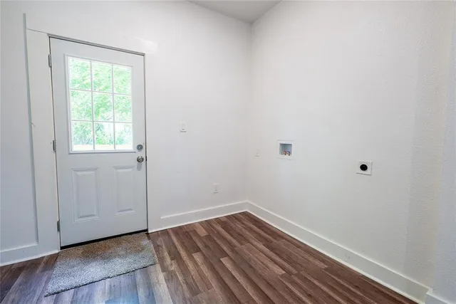 a view of a room with wooden floor and window