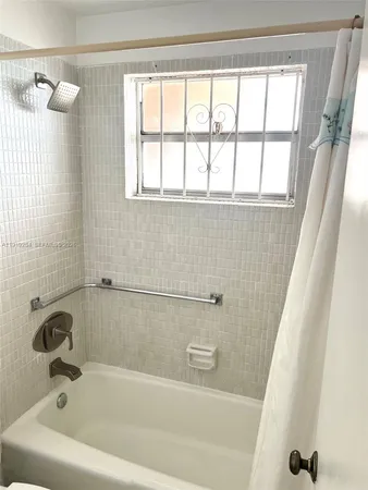 a white toilet sitting next to a bath tub shower