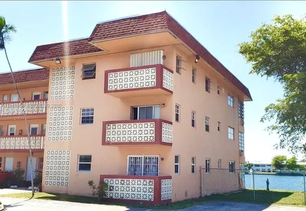a front view of a house with parking space