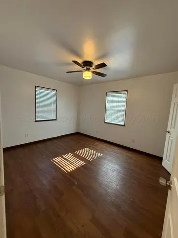 a view of wooden floor and windows in a room