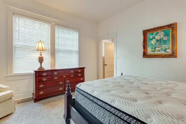 a bedroom with a bed and a dresser