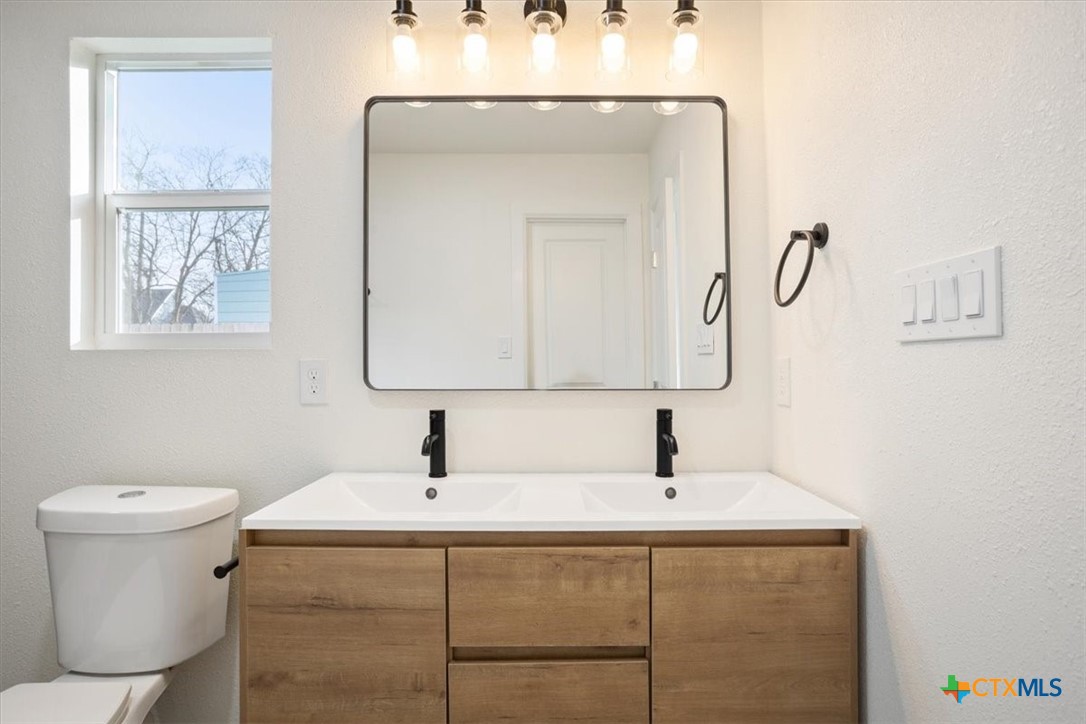 707 South 13th Street Temple, TX 76504 - Photo 15 of 24 a bathroom with a sink and a mirror