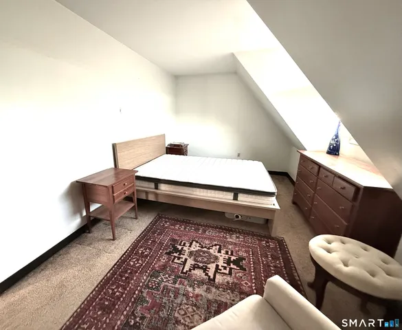 a living room with furniture and a rug