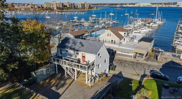 an aerial view of a house with outdoor seating