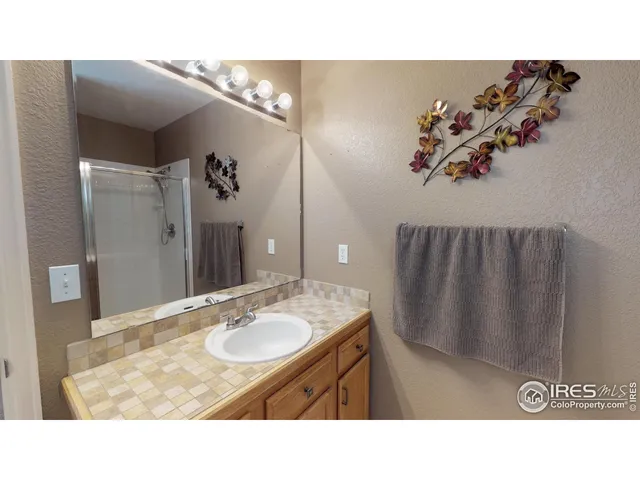 a bathroom with a sink vanity and a mirror