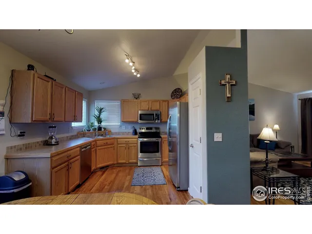 a open kitchen with cabinets and stainless steel appliances